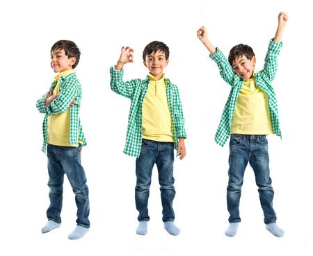 Boys making a victory sign on wooden chair over white background の写真素材