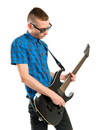 Young man playing guitar over white background の写真素材