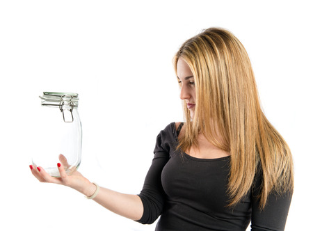 Pretty girl holding an empty bottle of glass over white の写真素材