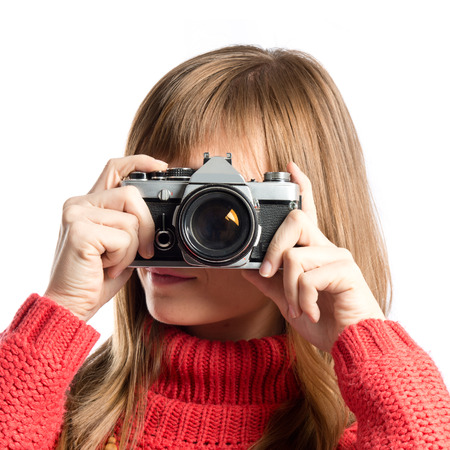 Girl taking a picture over white の写真素材