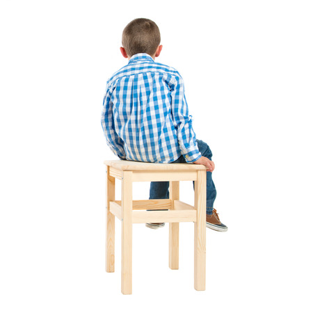back kid on wooden chair over white backgroundの写真素材