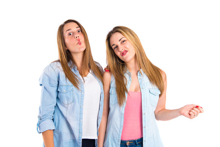 Friends doing a joke over isolated white の写真素材