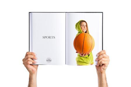 Blonde girl playing basketball printed on bookの写真素材