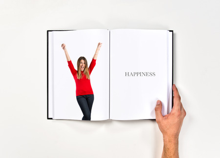 Young woman winner  printed on bookの写真素材