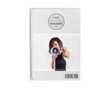 Pretty girl shouting with a megaphone printed on bookの写真素材