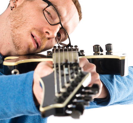Man with guitar over white background.の写真素材