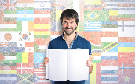 Man reading a book over flags backgroundの写真素材