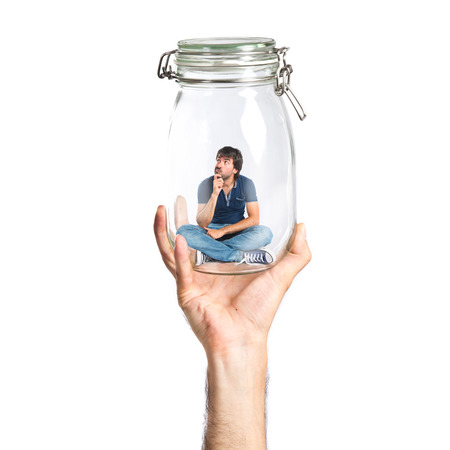 Man thinking inside jar glassの写真素材