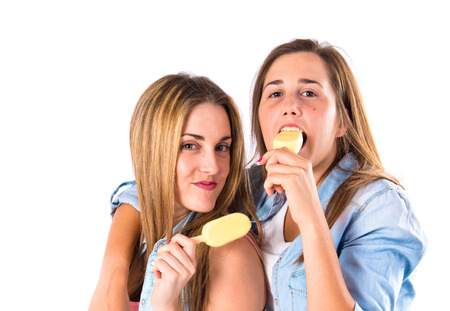 Friends eating ice cream over white の写真素材