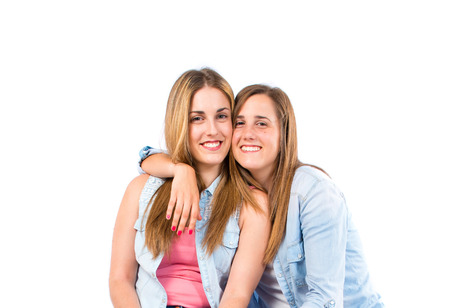 Sisters over white backgroundの写真素材