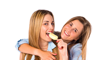 Friends eating ice cream over white backgroundの写真素材