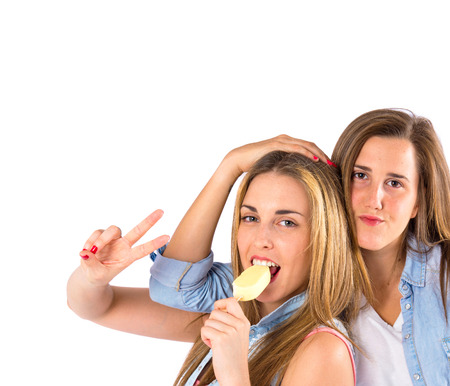 Friends eating ice cream over white backgroundの写真素材