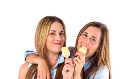 Friends eating ice cream over white backgroundの写真素材
