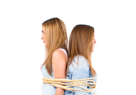 Sisters kidnapped and tied to a chairの写真素材