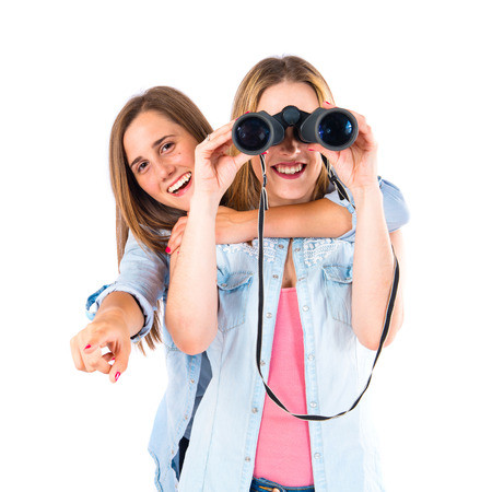 Friends with binoculars over isolated white backgroundの写真素材