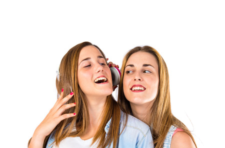 Friends listening music over white backgroundの写真素材