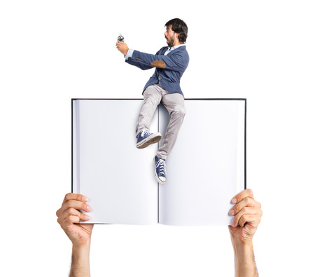 Man holding a clock on bookの写真素材
