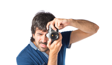 Man photographing over white backgroundの写真素材