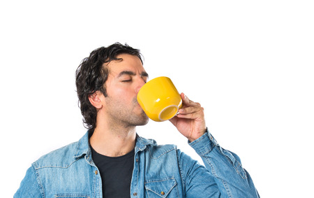 Man drinking coffee over white backgroundの写真素材