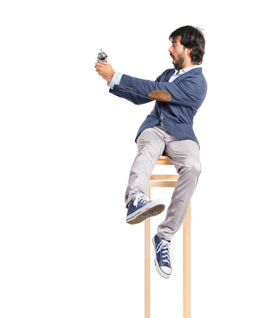 Man holding a clock over white backgroundの写真素材
