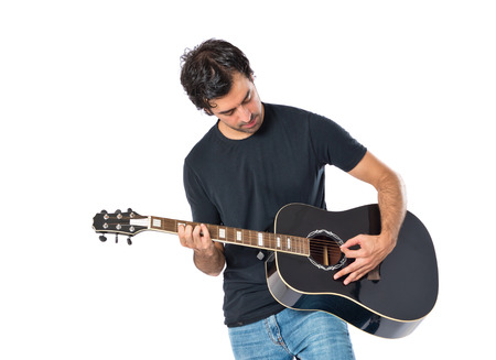 Handsome man with guitar over white background