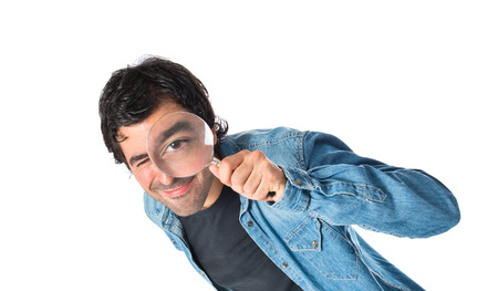 Man with magnifying glass over white backgroundの写真素材