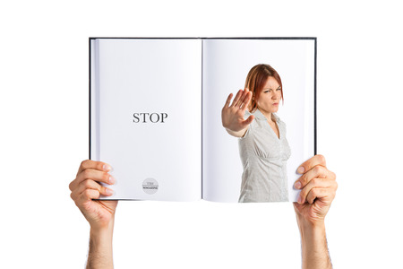 Pretty woman making stop sign  printed on bookの写真素材