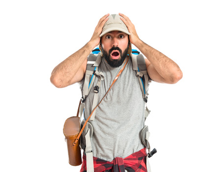 Backpacker doing surprise gesture over white backgroundの写真素材