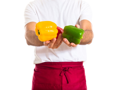 Chef holding colorful peppersの写真素材