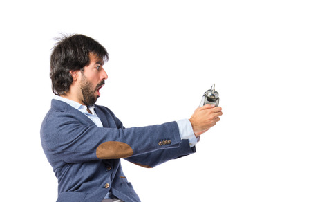 Man holding a clock over white backgroundの写真素材