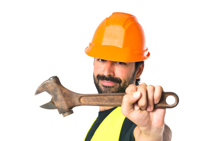 workman with wrench over white background