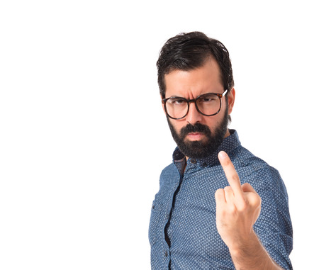 Young hipster man making horn gesture