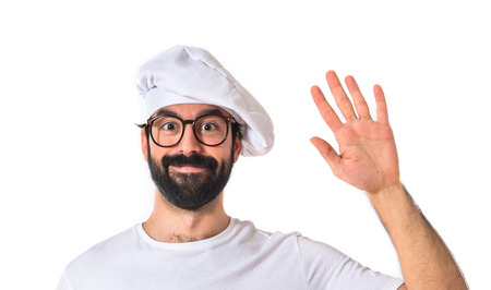 Chef saluting over white backgroundの写真素材