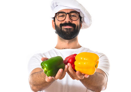 Chef holding colorful peppersの写真素材