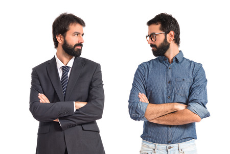 Brothers with his arms crossed over white backgroundの写真素材