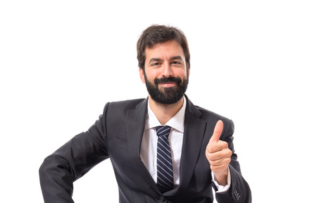 Businessman with thumb up over white backgroundの写真素材