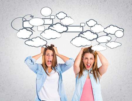 frustrated girls over grey backgroundの写真素材