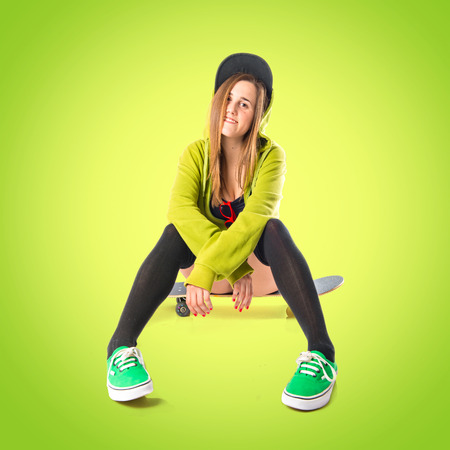 Pretty young girl wearing urban style with skateboardの写真素材