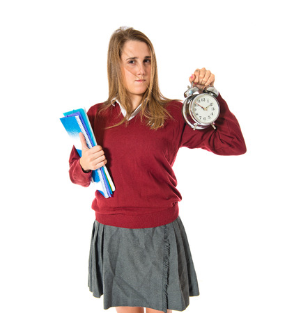 Student holding a clock over white backgroundの写真素材