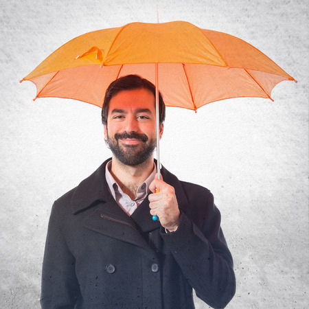 Man holding an umbrella over white backgroundの写真素材