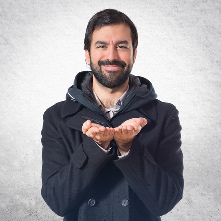 Man holding something over white backgroundの写真素材