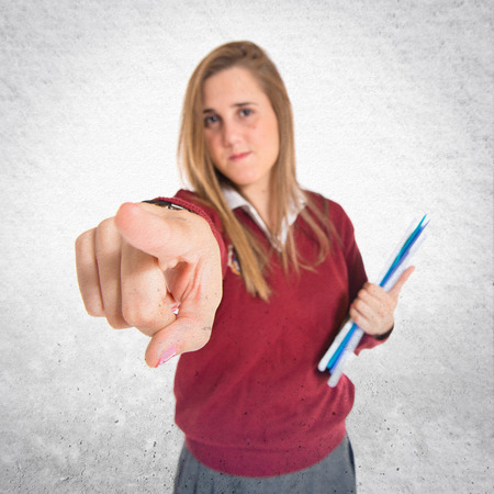 Student pointing to the front over white backgroundの写真素材