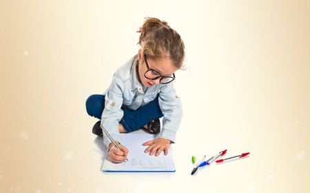 Blonde little girl writingの写真素材