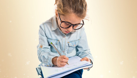 Little girl with glasses learning