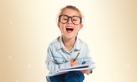 Little girl with glasses studingの写真素材