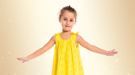 Blonde little girl dancing over white backgroundの写真素材