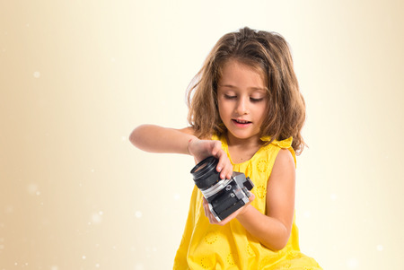Blonde little girl photographing something