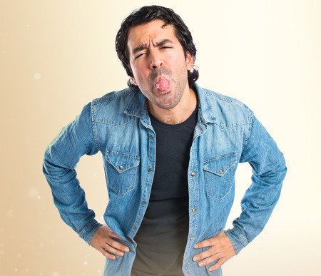 Man doing a joke over isolated white backgroundの写真素材