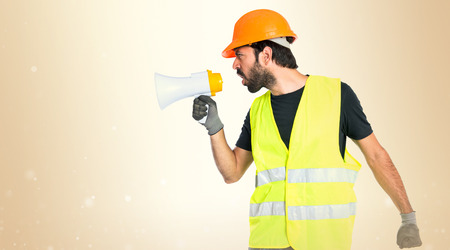 Workman shouting over isolated white backgroundの写真素材