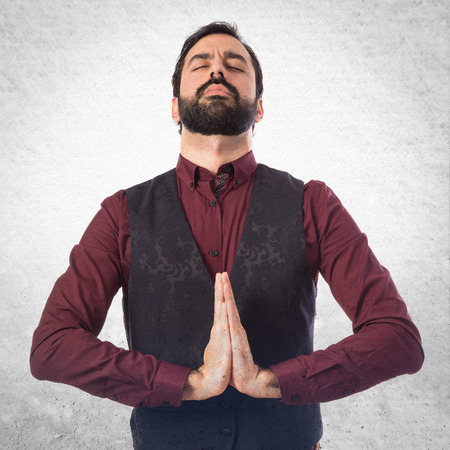 Man wearing waistcoat in zen positionの写真素材